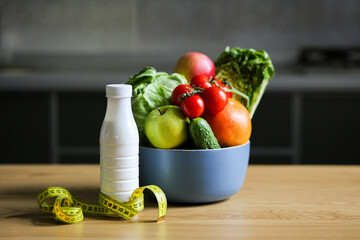 Diet concept. Nutrition for weight loss. Slimming products. Diet. Seasonal diet. Products for a slim figure. Weight loss. Concept with measure tape. Centimeter with groceries. Mediterranean diet