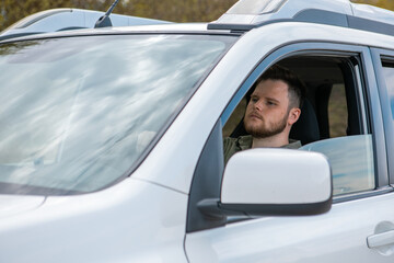 bearded man steering the car