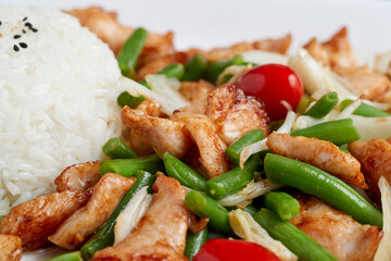 Roasted chicken breast with green bean pods, cherry tomatoes, served with rice