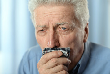 Portrait of sad sick senior man