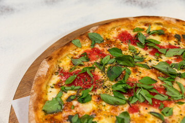 Pizza Margherita With Basil Cheese Rustic Tomato Sauce Homemade Artesanale Close Up Detail on a Round Wooden Plate with Flour Background Table