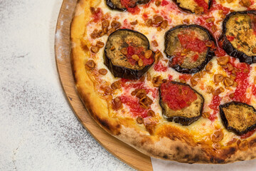 Pizza Aubergine Cheese Rustic Tomate Sauce Homemade Artesanale Close Up Detail on a Round Wooden Plate with Flour Background Table