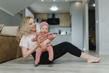 Portrait of young mother with cute baby at home