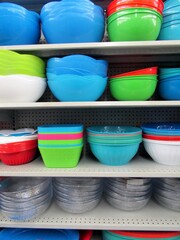 Colorful salad bowls on store shelves.