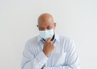 Depressed old elderly black business man. Sick African American person wearing a face mask thinking in medical treatment and health care isolated on white. Coronavirus. People lifestyle.