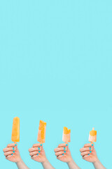 unknown person holding an orange ice cream