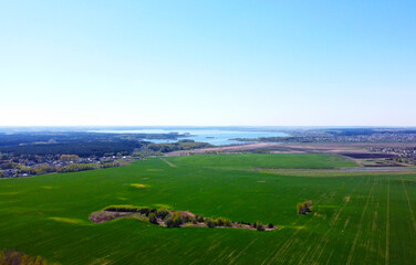 Obraz premium Aerial view of the summer landscape with green fields and meadows