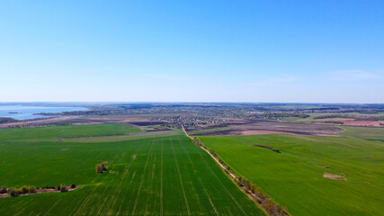 Obraz premium Aerial view of the summer landscape with green fields and meadows