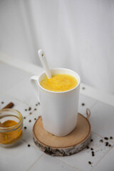Traditionnal golden latte in a white mug