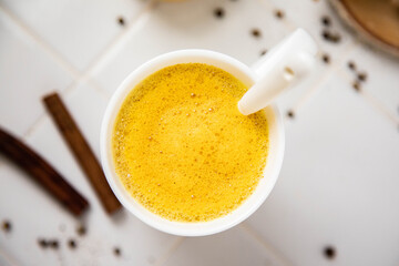 Traditionnal golden latte in a white mug