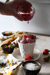 vegan strawberry ice cream with fresh fruits in a cup