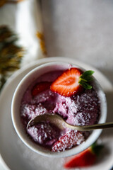 vegan strawberry ice cream with fresh fruits in a cup