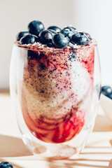 Healthy chia pudding in a glass with fresh blueberries