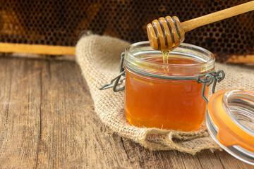 a jar of honey and honey dipper