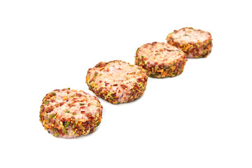 Raw meat patties with spices, four pork cutlets isolated on white