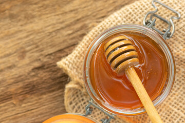 a jar of honey and honey dipper