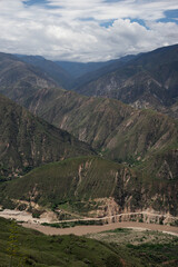 view of mountain vertical and river erosion with clouds