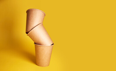 Eco natural paper cups on yellow background. Sustainable lifestyle concept. zero waste, plastic...