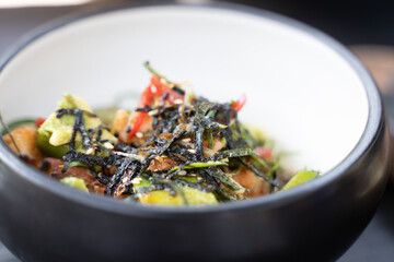Fried vegetables bowl with seaweed closeup. Healthy vegetarian food concept