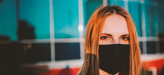 Portrait of a cool young Teenager caucasian girl wearing black mask looking at camera