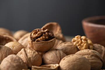 Tasty cracked walnut on heap of nuts. Close up view