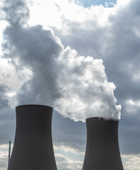 Nuclear power plant against sky at sunset