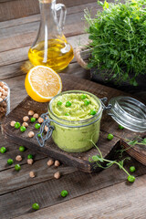 Green peas hummus with chickpeas and olive oil. Vegetarian snack.
