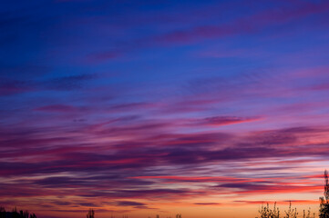 Fototapeta premium Landscape with dramatic light - beautiful golden sunset with saturated sky and clouds.