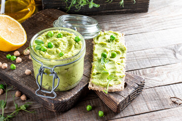 Pea green dip on a crackers. Hummus concept. Top view. Copy space