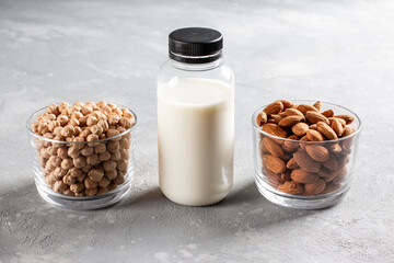 Alternative vegan milk in bottle on a concrete background. Chickpea or almond milk. Non-dairy lactose free milk.