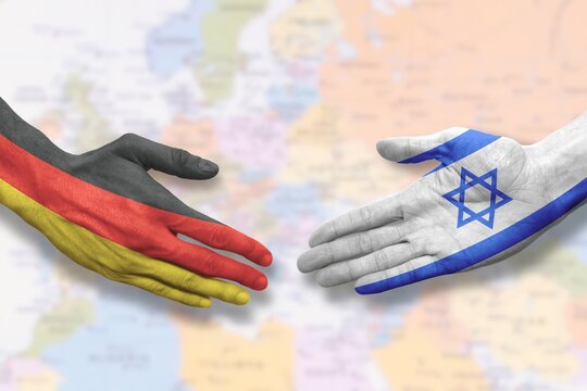 Israel and Germany - Flag handshake symbolizing partnership and cooperation