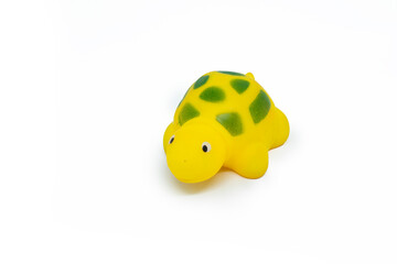 Yellow colored plastic tortoise toy isolated on white background