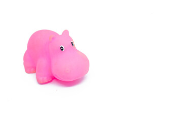 Pink colored plastic hippopotamus toy isolated on white background.