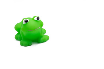 Smiling Green plastic toy of frog on white background.