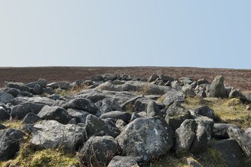 the exposed stones at the top of a cairn known as the millers grave on midgley moor in calderdale west yorkshire