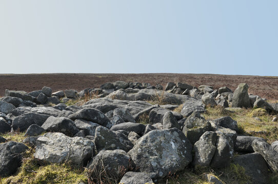 the exposed stones at the top of a cairn known as the millers grave on midgley moor in calderdale west yorkshire