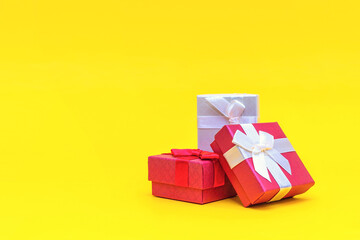 Gift boxes on a yellow background. Red gift boxes, open box. Postcard for printing. panoramic photo, large size, empty space for congratulations or design