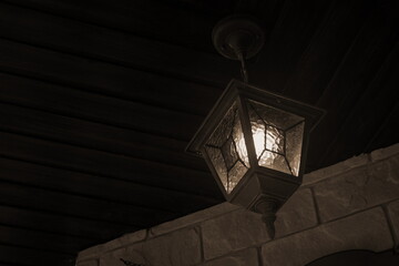 Vintage Glowing Street Lamp Hang On Wooden Ceiling In Garden Yard. Dark Night Old Lantern Light...