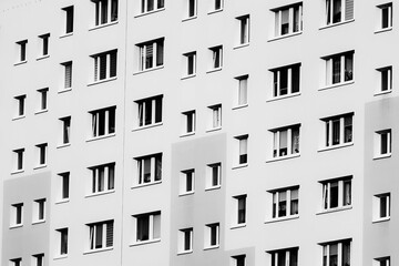 Windows in the block of flats. Urban view. Conceptual image, parallel and symmetrical lines of the building.