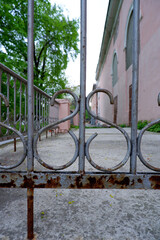 Fototapeta na wymiar Rusty metal fence made of twisted rods