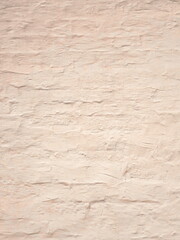 Beige shabby brick wall background, old stone brickwork plaster