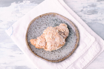 Croissant on bright wooden background. Top view. Close up. 