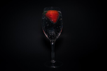 Glass of wine field with strawberry and sparkling water