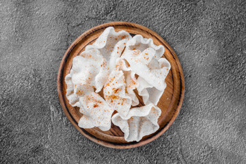 Rice chips on a wooden board on a gray background. Top view.