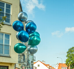 Colorful latex balloons over the city old town. Urban scene. Happy birthday.