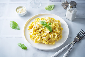 Fresh prepared Tortellini pasta with basil in a plate