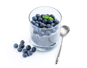 Chia seed pudding with blueberry in clear glass isolated on white