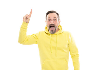mature surprised man pointing finger up. smiling senior guy presenting product isolated on white