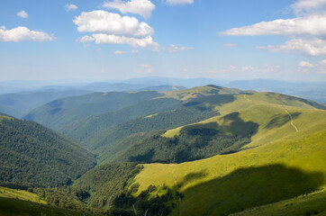 Beautiful alpine landscape of mountain ridge Borzhava with rolling grassy hills during a sunny summer day