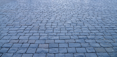 Abstract background. Old cobblestone pavement close up.